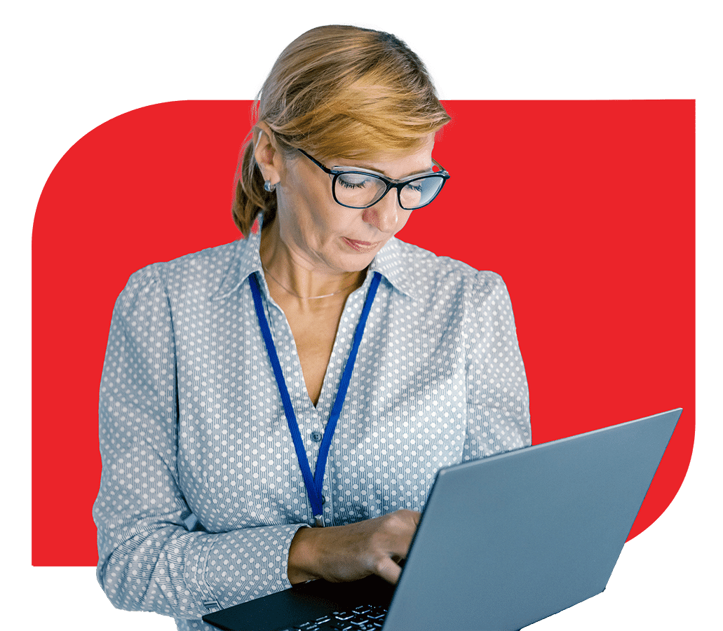 A woman in glasses is using a laptop to work on tasks related to Fogo Solutions.