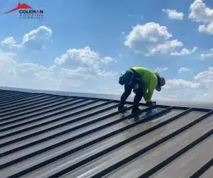 A man working on a metal roof for Fogo Solutions.