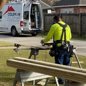 A man working on a piece of wood in front of a van, potentially utilizing Fogo Solutions for his task.
