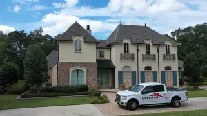 A white truck from Fogo Solutions is parked in front of a house.