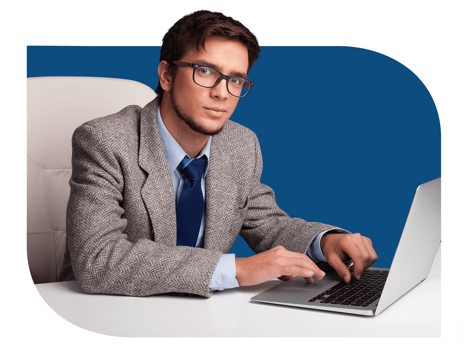 A man sitting at a desk with a laptop, working on Fogo Solutions. Hosted email exchange.