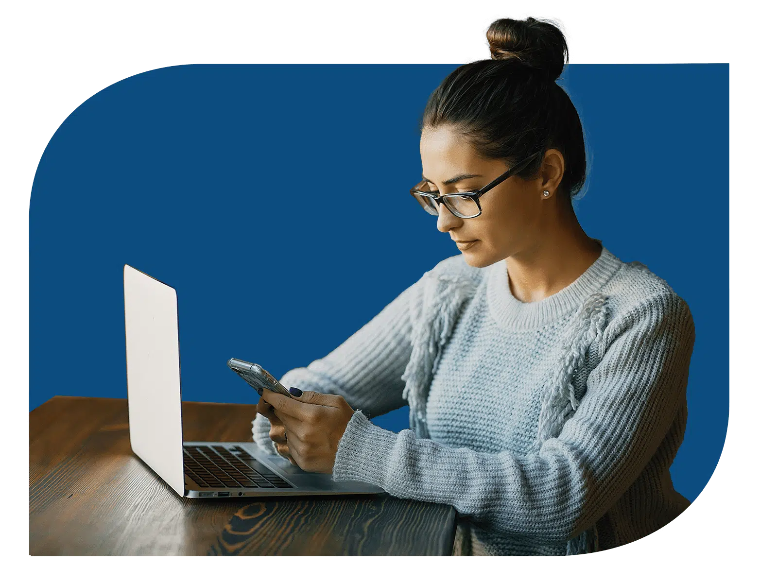 A woman using fogo solutions on a laptop and cell phone. A woman using fogo solutions on a laptop and cell phone. Business communications. Master agent.
