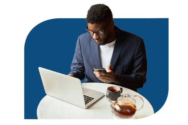 cloud_computing man at coffee shop on laptop and phone